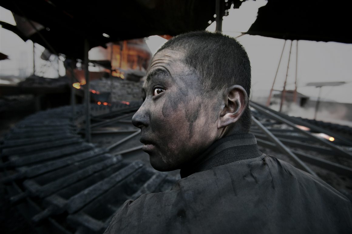 Lu Guang, Worker in a small smeltering factory, Wuhai City, Inner Mongolia, 2005